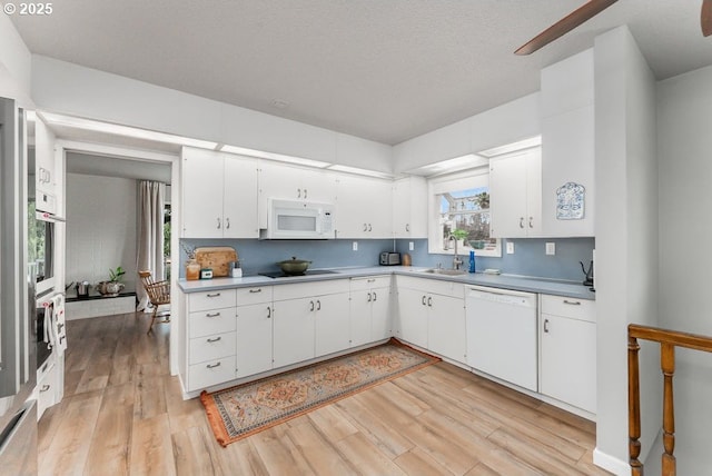 185 W Oriole Dr, Roseburg, OR 97471 - kitchen featuring light wood-style floors, white appliances, white cabinetry, light countertops, and a sink
