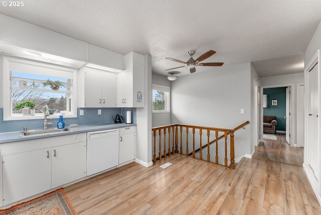 185 W Oriole Dr, Roseburg, OR 97471 - kitchen featuring light wood-style floors, ceiling fan, white cabinetry, a sink, and white dishwasher