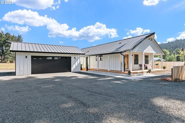 31395 Kenady Ln, Cottage Grove, OR 97424 - modern farmhouse with board and batten siding, metal roof, a porch, a garage, and a standing seam roof