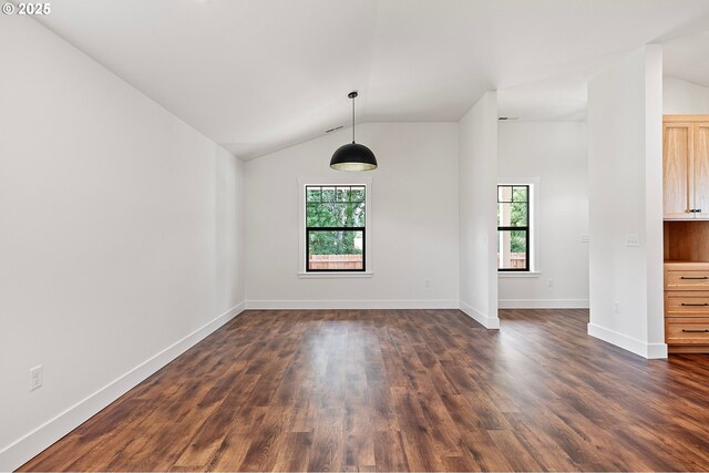 31395 Kenady Ln, Cottage Grove, OR 97424 - empty room with plenty of natural light, lofted ceiling, dark wood finished floors, and baseboards