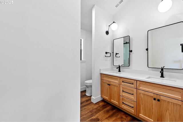 31395 Kenady Ln, Cottage Grove, OR 97424 - bathroom with double vanity, toilet, wood finished floors, and baseboards