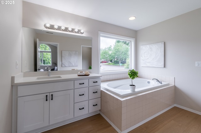 10134 SE 54th Ct, Milwaukie, OR 97222 - full bathroom featuring vanity, healthy amount of natural light, a bath, and wood finished floors
