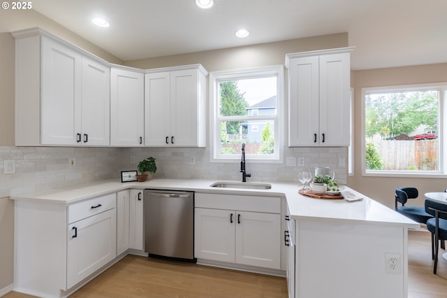 10134 SE 54th Ct, Milwaukie, OR 97222 - kitchen featuring dishwasher, a sink, a peninsula, white cabinets, and recessed lighting