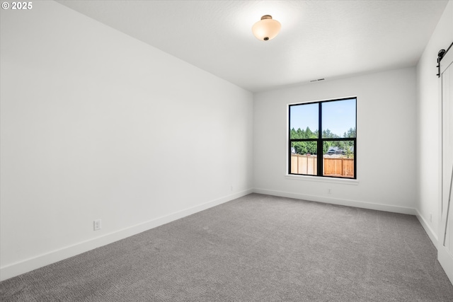 88109 Jameson Way, Veneta, OR 97487 - carpeted spare room with a barn door and baseboards