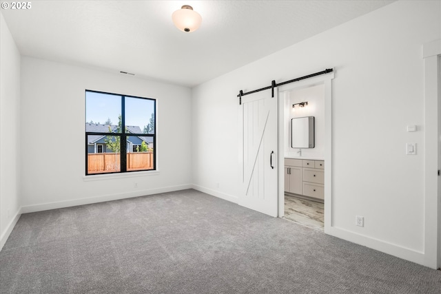 88109 Jameson Way, Veneta, OR 97487 - unfurnished bedroom featuring a barn door, carpet, and baseboards