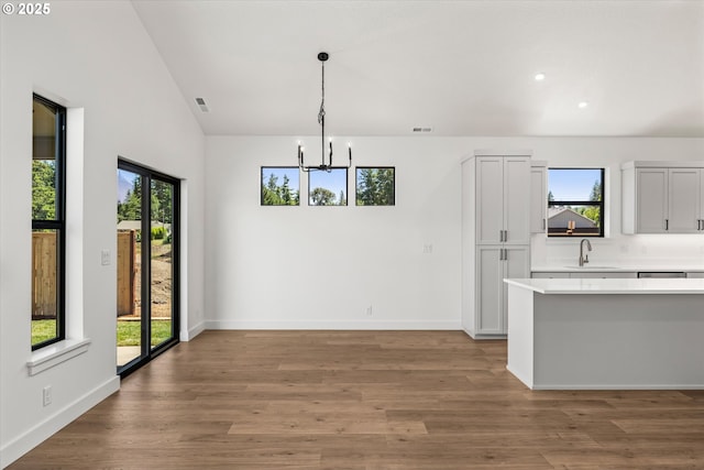 88109 Jameson Way, Veneta, OR 97487 - unfurnished dining area with a sink, a chandelier, plenty of natural light, light wood-style flooring, and lofted ceiling