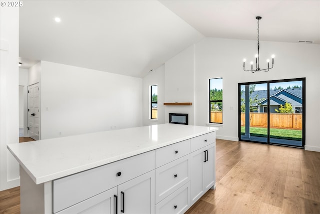 88109 Jameson Way, Veneta, OR 97487 - kitchen featuring open floor plan, a chandelier, light countertops, high vaulted ceiling, and decorative light fixtures