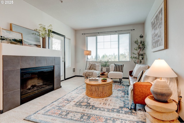 695 NW Falling Waters Ln Unit 304, Portland, OR 97229 - sitting room featuring a tile fireplace, carpet floors, and baseboards
