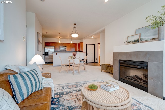 695 NW Falling Waters Ln Unit 304, Portland, OR 97229 - living area with light carpet, a tile fireplace, and rail lighting