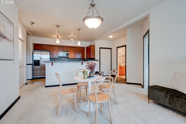 695 NW Falling Waters Ln Unit 304, Portland, OR 97229 - dining room with light carpet and baseboards