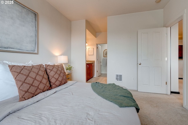 695 NW Falling Waters Ln Unit 304, Portland, OR 97229 - bedroom featuring light carpet and ensuite bath