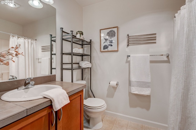 695 NW Falling Waters Ln Unit 304, Portland, OR 97229 - bathroom with vanity, toilet, baseboards, tile patterned floors, and curtained shower
