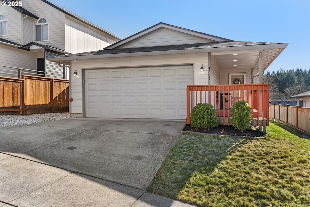 view of front of property featuring a garage and a front lawn