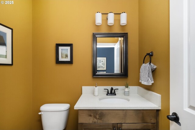 bathroom featuring vanity and toilet