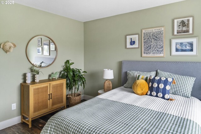 bedroom with dark wood-style flooring and baseboards