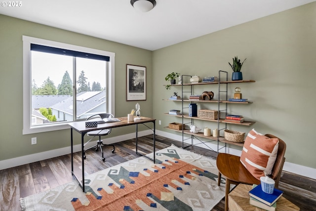 office space with baseboards and wood finished floors