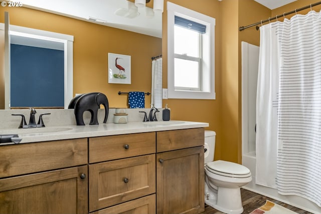 bathroom featuring a sink, toilet, double vanity, and visible vents