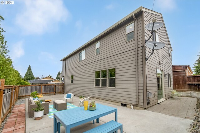 back of property featuring a fenced backyard, outdoor lounge area, and a patio area