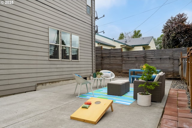 view of patio with an outdoor living space and a fenced backyard