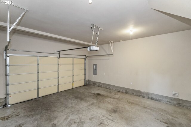 garage featuring a garage door opener and electric panel