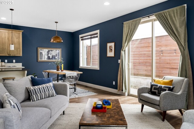 living room with light wood-type flooring, recessed lighting, and a wealth of natural light