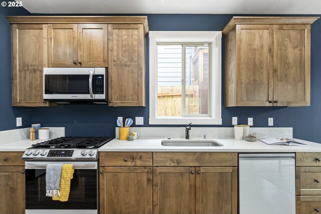 kitchen featuring light countertops, a sink, and stainless steel appliances