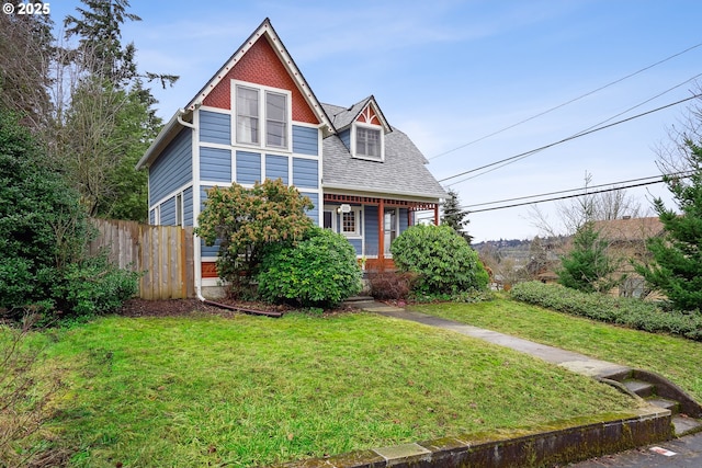 view of front of house featuring covered porch and a front lawn