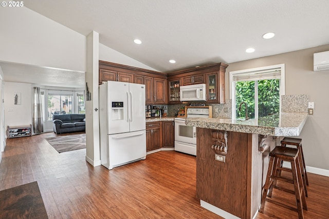 2812 NE Delancey Ct, Vancouver, WA 98682 - kitchen featuring white appliances, lofted ceiling, a peninsula, glass insert cabinets, and healthy amount of natural light