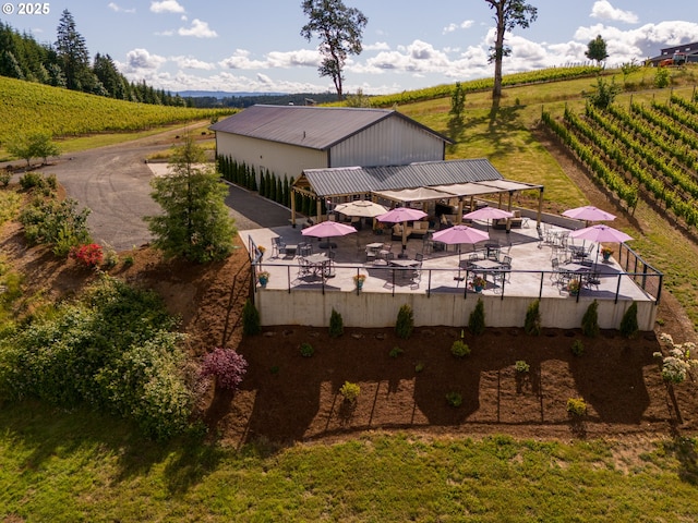 back of property featuring a gazebo, fence, a rural view, and metal roof