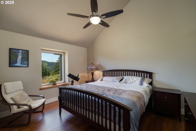 bedroom with baseboards, ceiling fan, wood finished floors, and lofted ceiling
