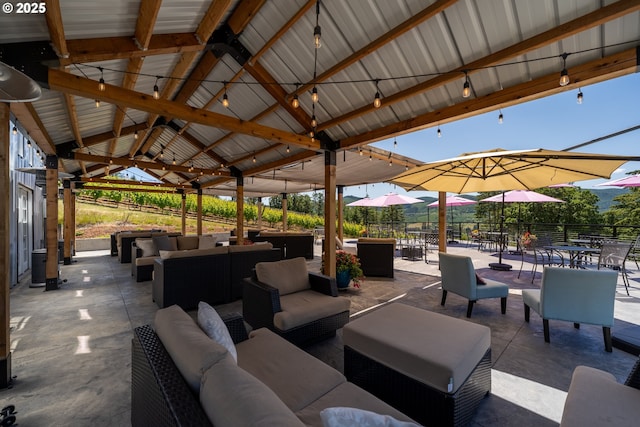 view of patio featuring a gazebo, fence, and an outdoor hangout area