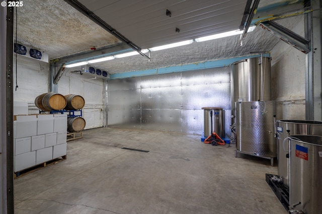 basement featuring water heater and a garage