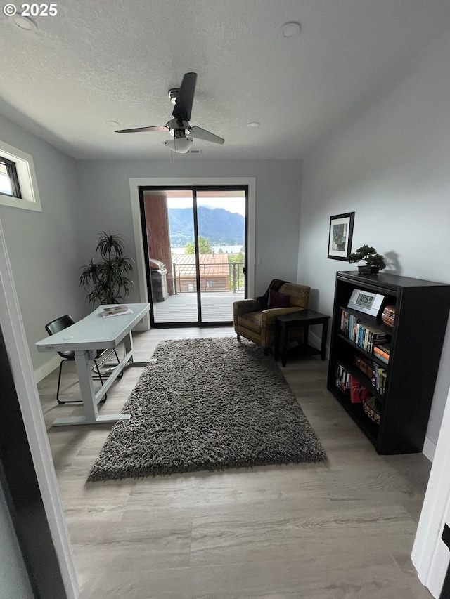 113 NW Willard St, Stevenson, WA 98648 - sitting room with a ceiling fan, light wood-style flooring, and a textured ceiling