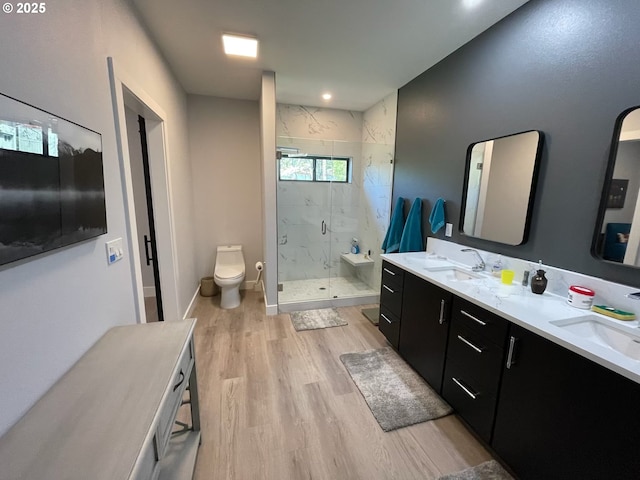 113 NW Willard St, Stevenson, WA 98648 - bathroom featuring a marble finish shower, wood finished floors, double vanity, and toilet