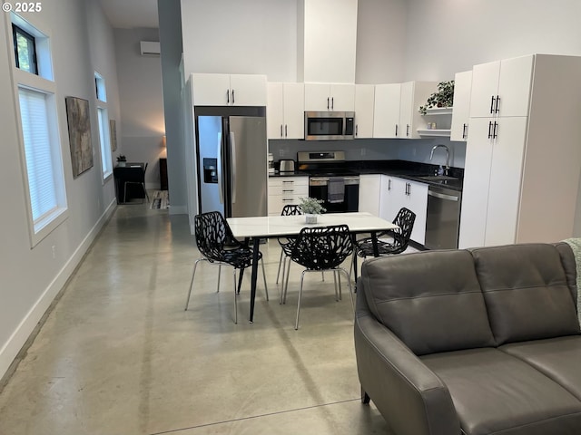 113 NW Willard St, Stevenson, WA 98648 - kitchen with stainless steel appliances, a high ceiling, baseboards, open shelves, and dark countertops