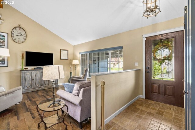 entryway with baseboards, vaulted ceiling, and a healthy amount of sunlight
