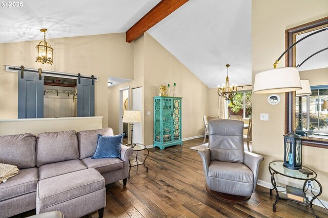 living area featuring plenty of natural light, beam ceiling, dark wood-type flooring, a barn door, and a notable chandelier