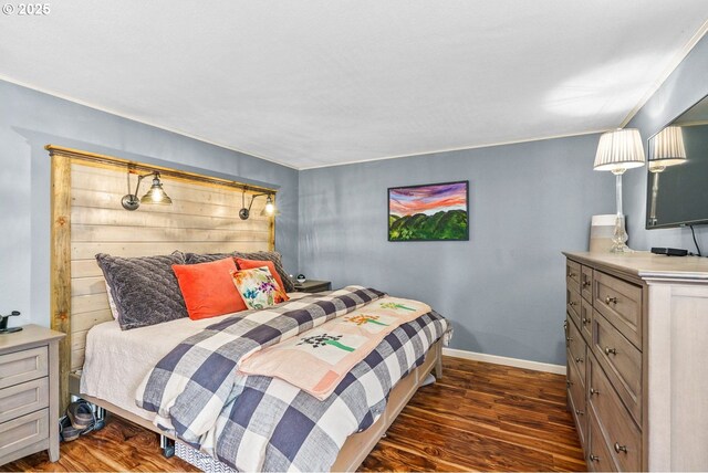 bedroom featuring dark wood-type flooring and baseboards