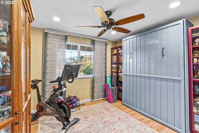 workout room featuring baseboards, wood finished floors, ceiling fan, and recessed lighting
