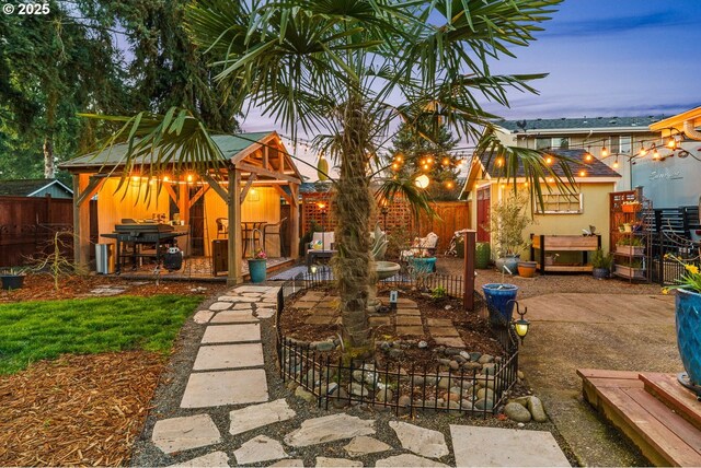 view of yard featuring a fenced backyard, a gazebo, and a patio