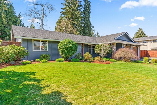 ranch-style house with a front lawn and fence