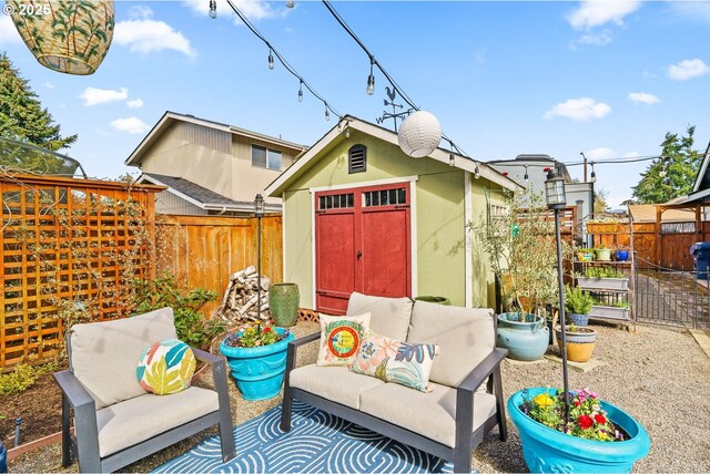 view of outdoor structure with a fenced backyard, an outbuilding, and an outdoor living space
