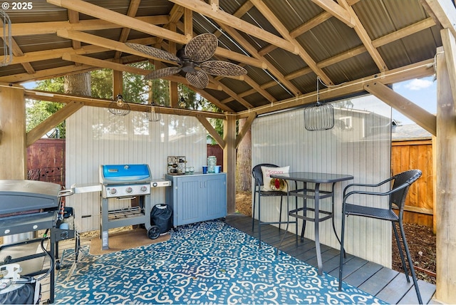 exterior space featuring a grill, fence, and a gazebo