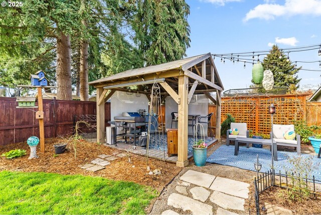 view of patio / terrace with grilling area, a gazebo, and fence private yard