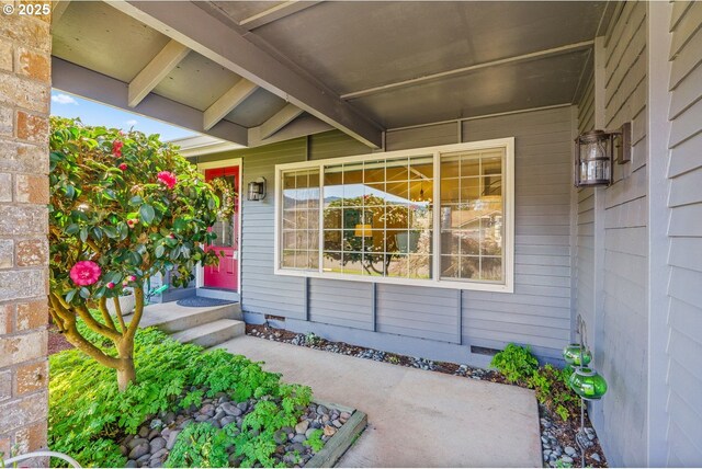 property entrance featuring a porch and crawl space