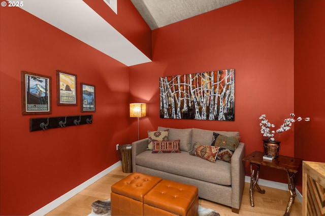 sitting room with baseboards and wood finished floors