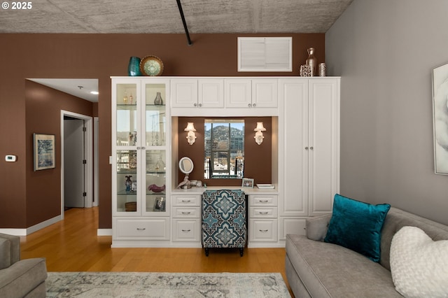 sitting room featuring baseboards, visible vents, and light wood finished floors