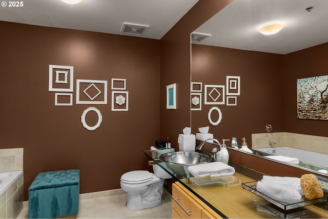 bathroom featuring tile patterned floors, visible vents, toilet, and a bath