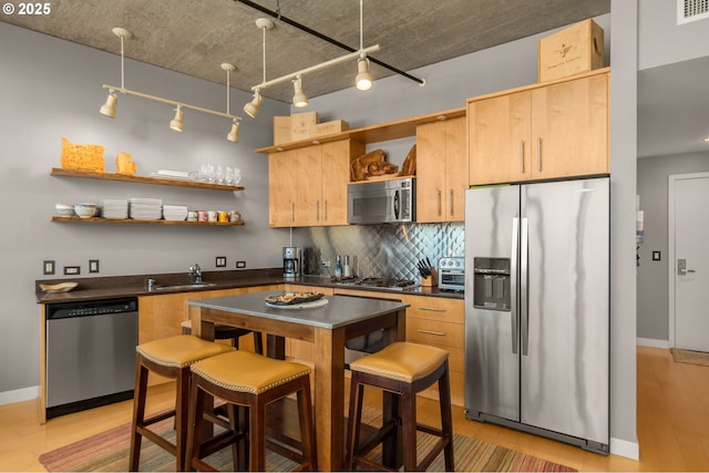 kitchen with dark countertops, appliances with stainless steel finishes, open shelves, and decorative backsplash