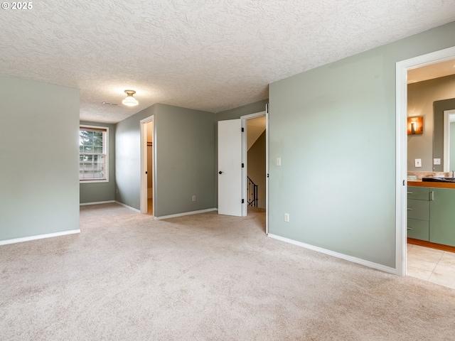 2487 Southslope Way W, Linn, OR 97068 - spare room featuring light colored carpet, a textured ceiling, and baseboards